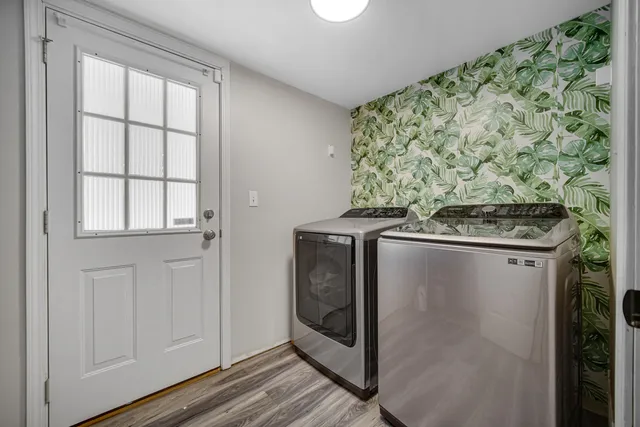 a view of a storage and utility room with washer and dryer