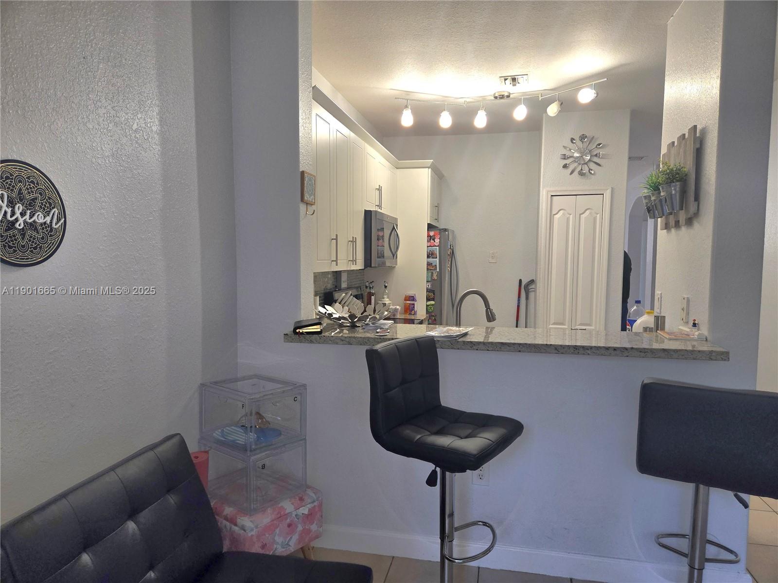 2731 Southeast 17th Avenue, Unit 100 Homestead, FL 33035 - Photo 4 of 12 a bathroom with a sink and a mirror