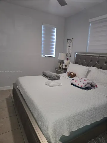 a bedroom with bed and window