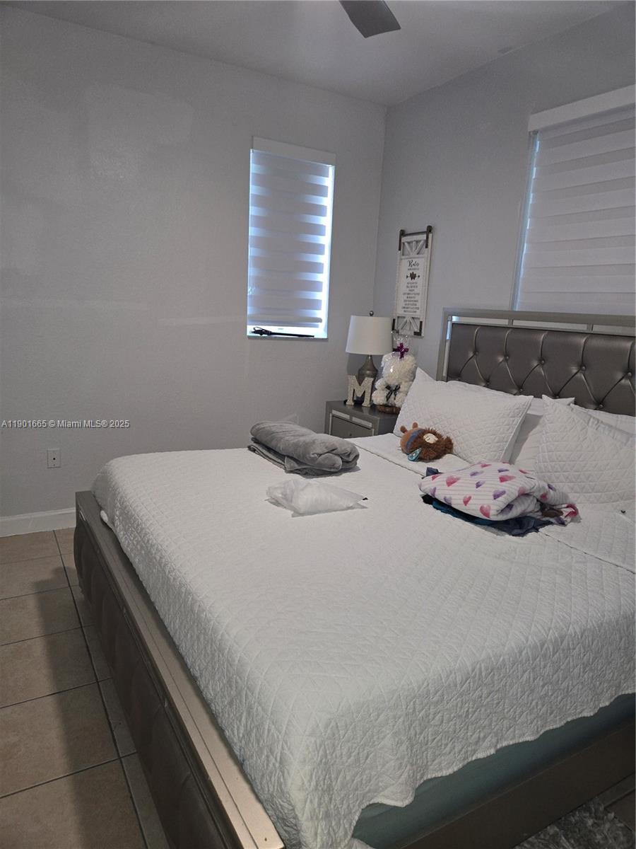 2731 Southeast 17th Avenue, Unit 100 Homestead, FL 33035 - Photo 6 of 12 a bedroom with bed and window