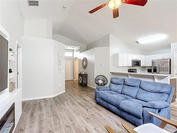 a living room with furniture and a wooden floor
