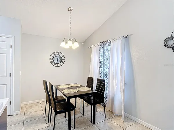 a view of a dining room with a table and chairs