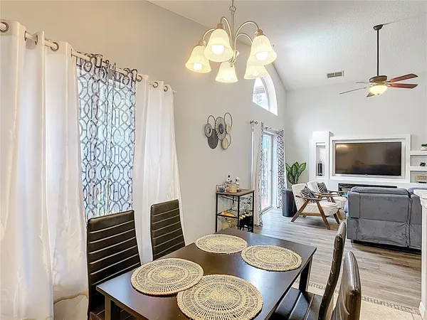 a view of a dining room with furniture wooden floor and chandelier