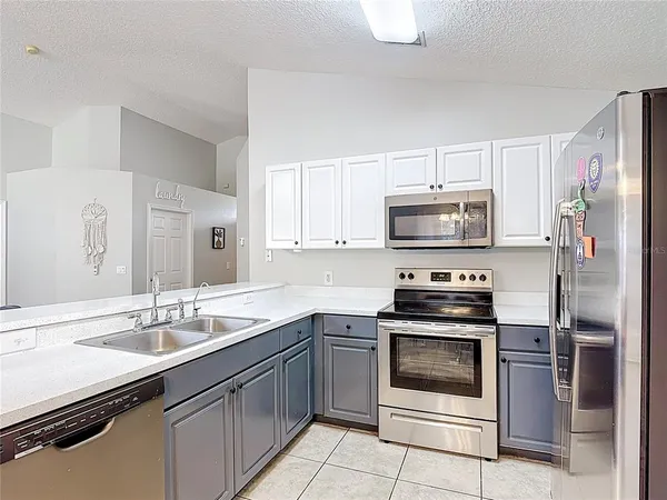 a kitchen with a sink stove and microwave