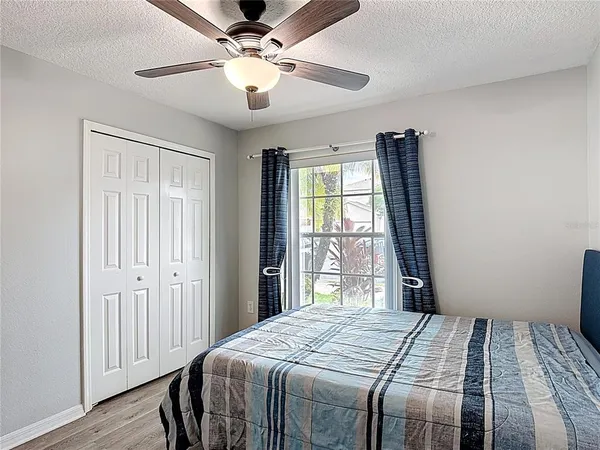 a bedroom with a large bed and a window