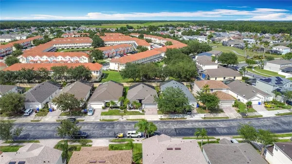 an aerial view of residential houses with outdoor space and swimming pool