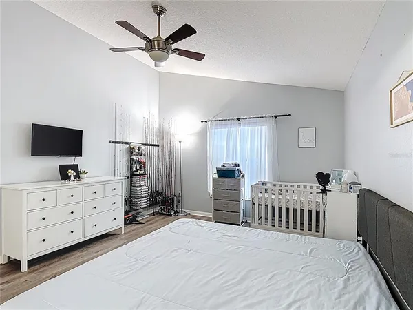 a bedroom with furniture and a flat tv screen