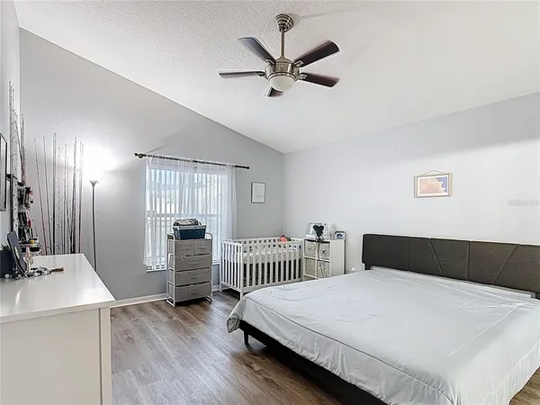 a bedroom with a bed and a chandelier