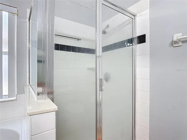 a bathroom with a shower and a sink