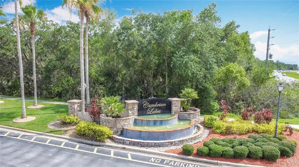 a view of a building with a yard and potted plants