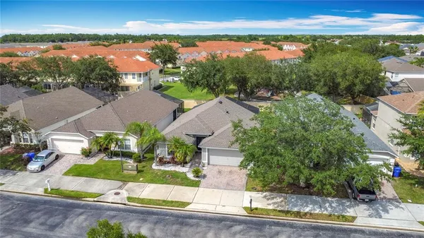 an aerial view of a house with a garden and lake view