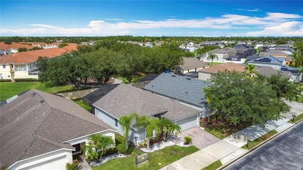 an aerial view of residential houses with outdoor space and street view