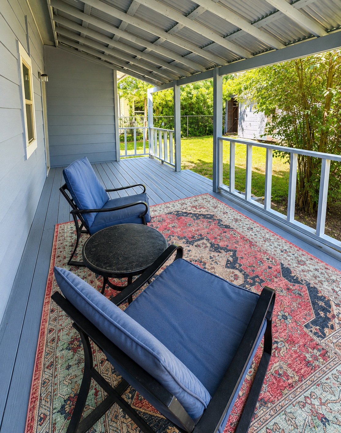 810 North 6th Street Temple, TX 76501 - Photo 7 of 9 A welcoming covered porch with a durable metal roof overlooks a verdant private yard.