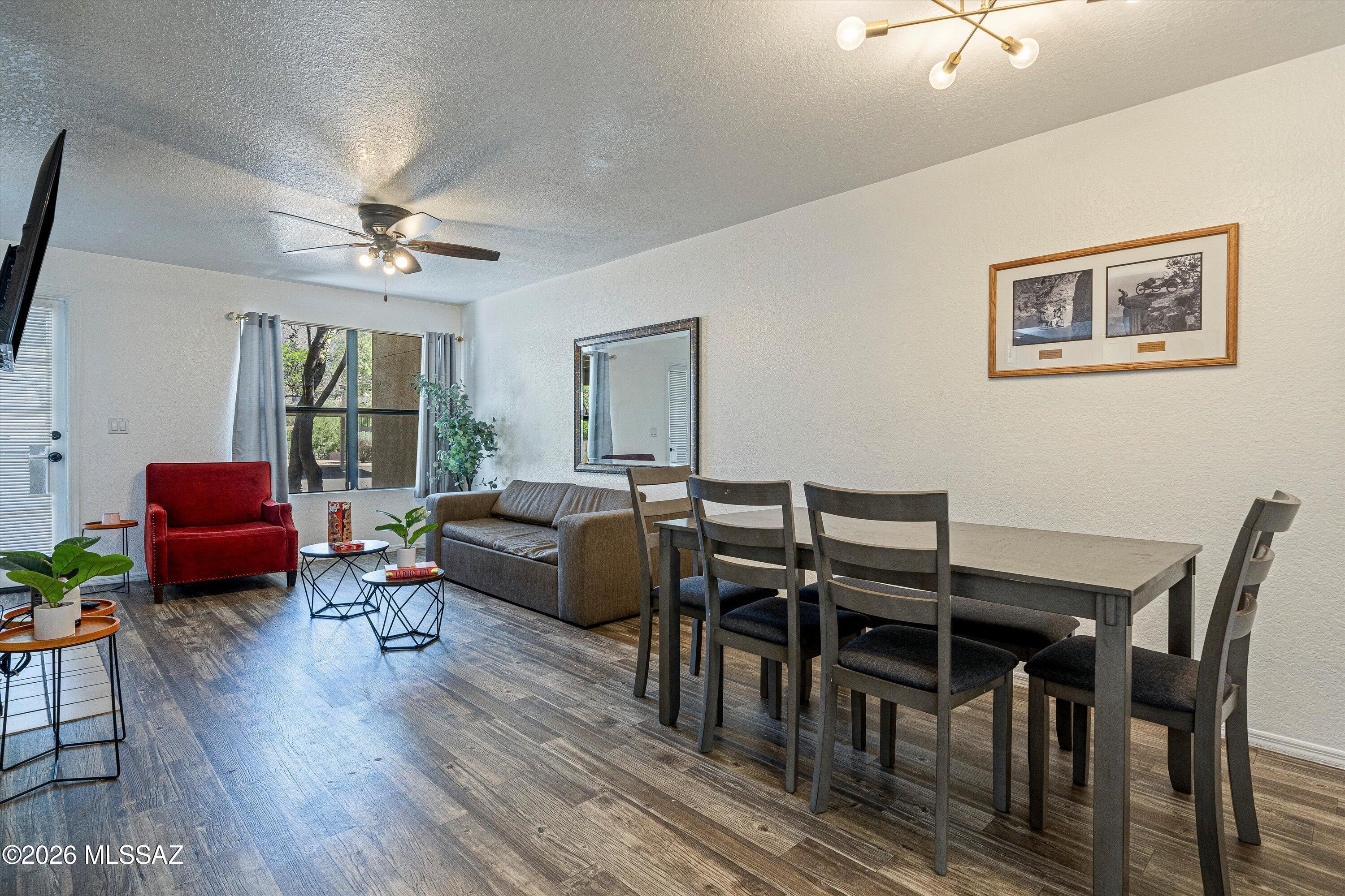 5800 North Kolb Road, Unit 1102 Tucson, AZ 85750 - Photo 7 of 36 a living room with furniture a fireplace and a flat screen tv