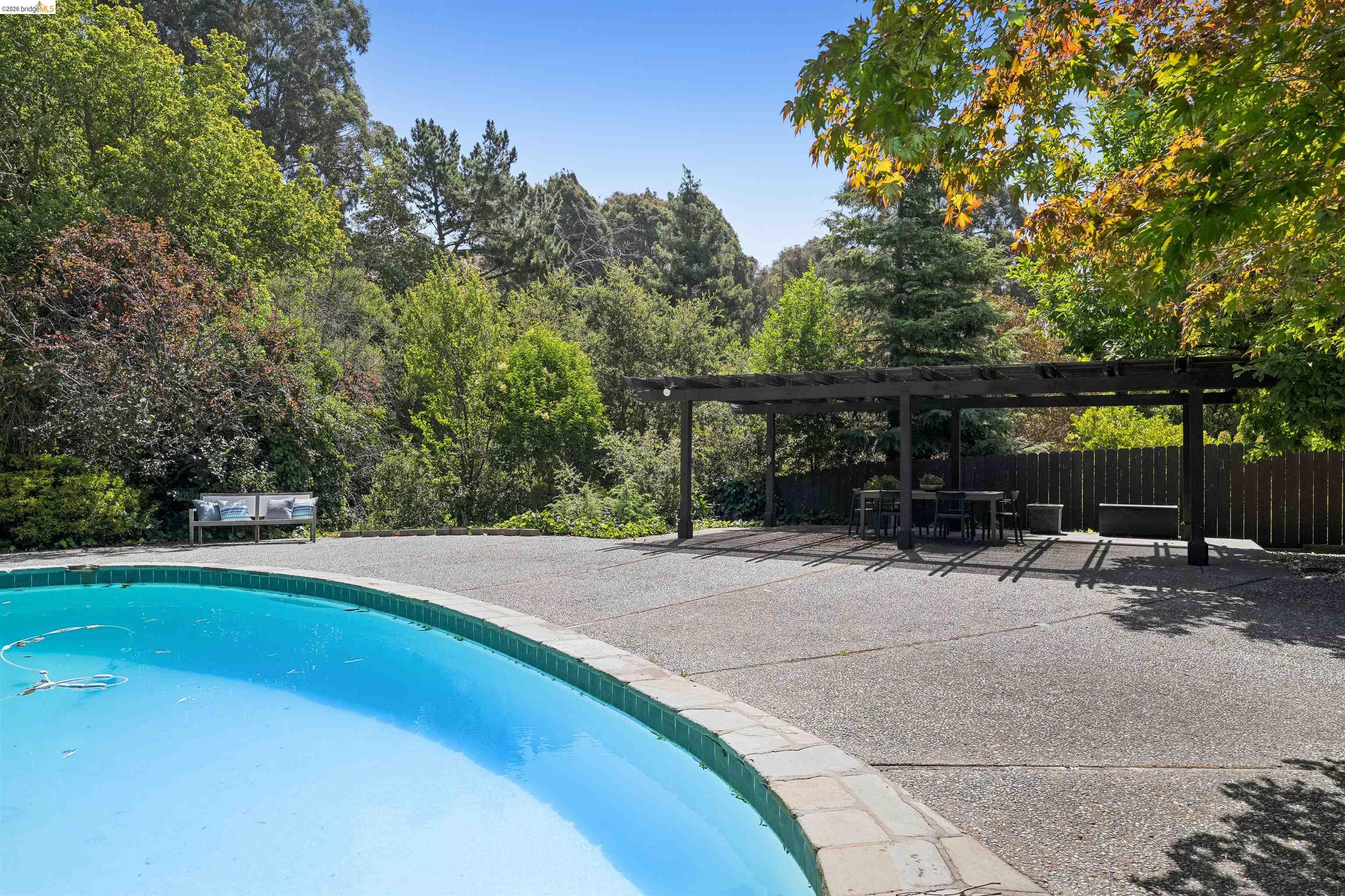 7 Jo Lin Court El Sobrante, CA 94803 - Photo 90 of 99 Expansive outdoor patio featuring an inground swimming pool with stone coping and a large exposed aggregate deck
