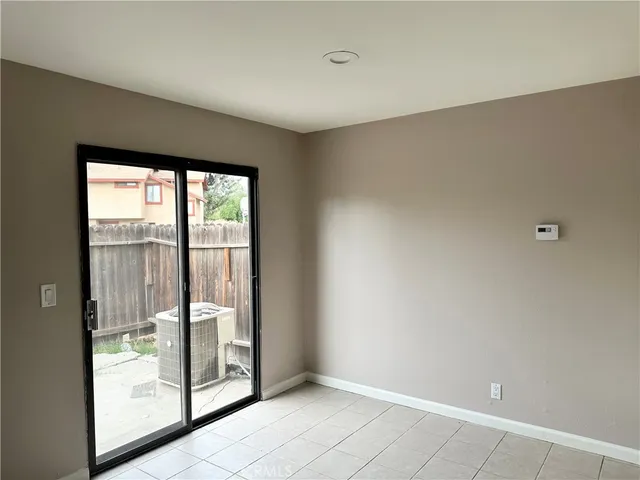 a view of an empty room with glass door
