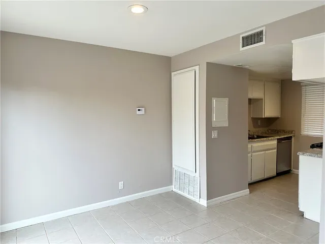 a view of kitchen with refrigerator cabinets and stove