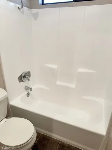 a bathroom with a toilet and a bathtub