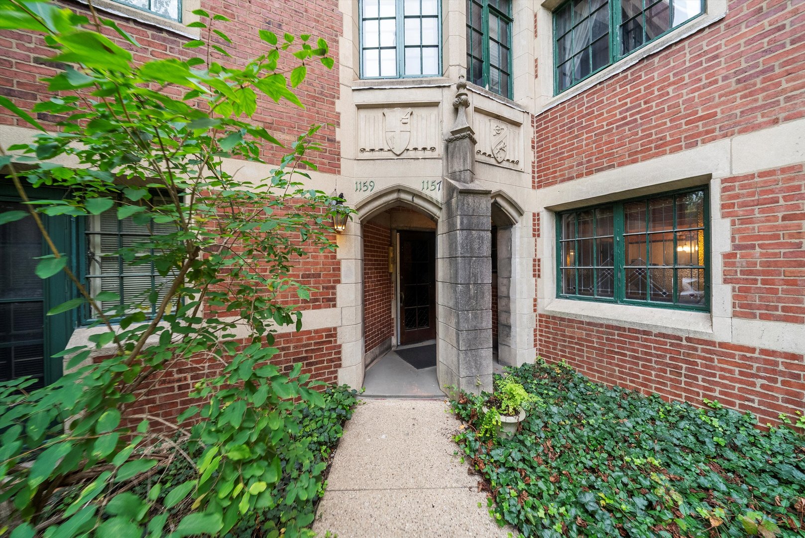 1157 East 56th Street, Unit 3 Chicago, IL 60637 - Photo 2 of 14 a front view of a house with a garden