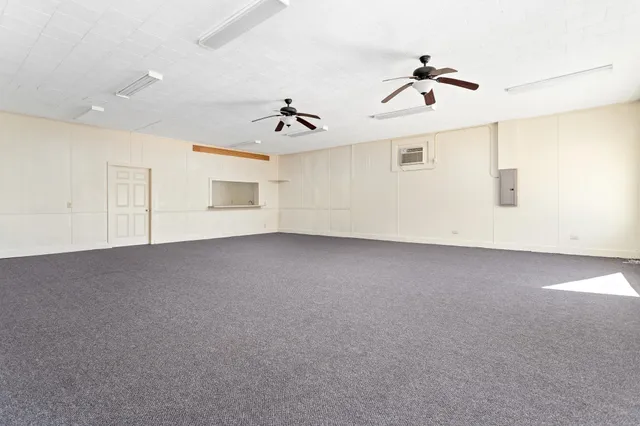 a view of a livingroom with a ceiling fan and window