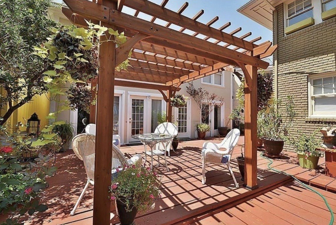 a view of a patio with table and chairs and potted plants