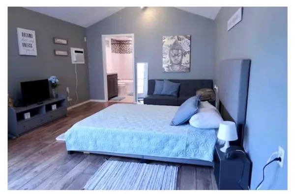 a bedroom with a bed and a flat screen tv