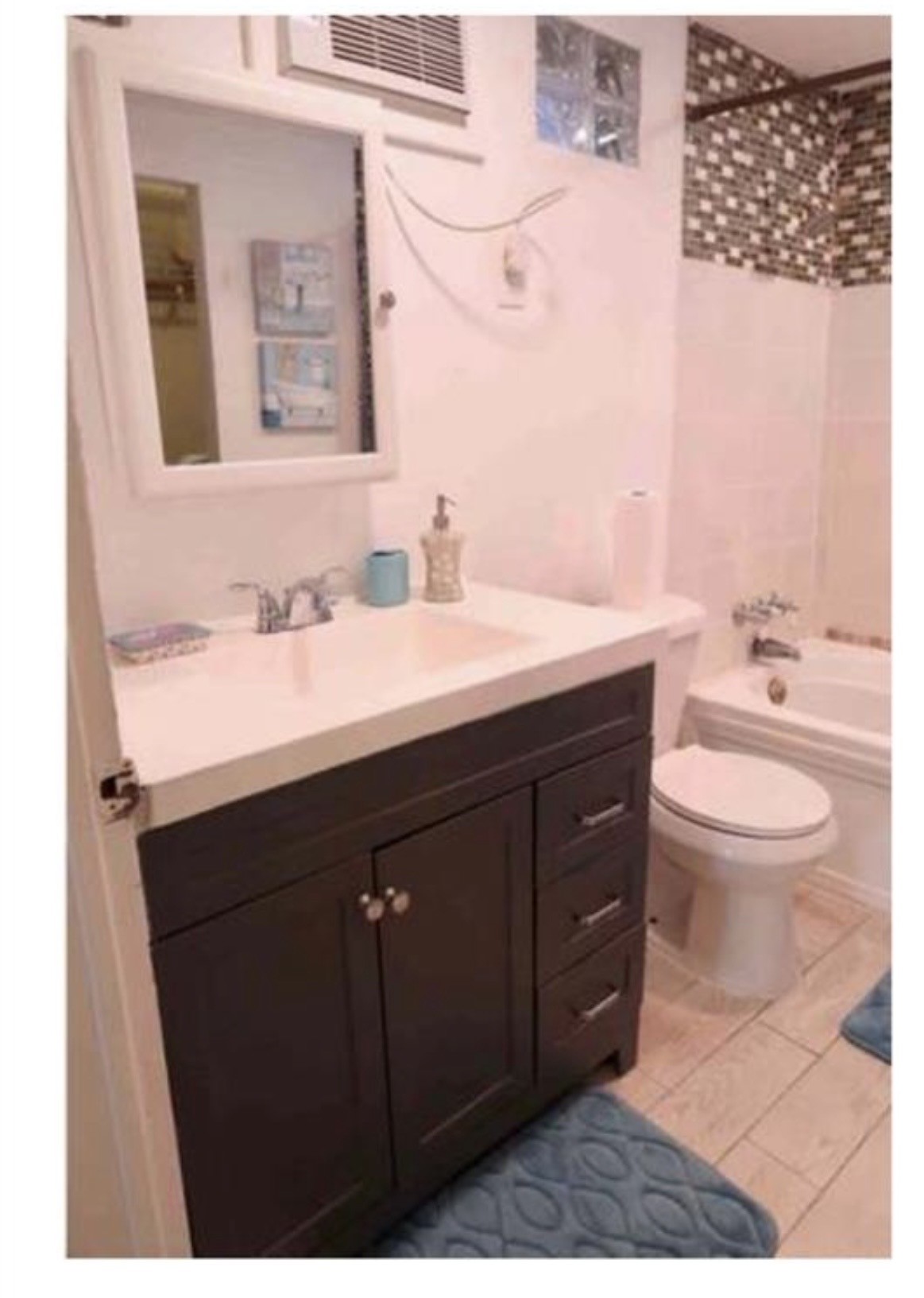 2606 Stanford Street, Unit 5 Houston, TX 77006 - Photo 5 of 6 a bathroom with a sink a toilet a mirror and shower