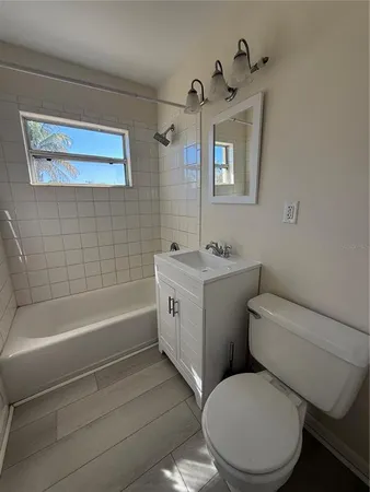 a bathroom with a sink a toilet and bathtub