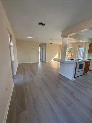 wooden floor in an empty room with a fireplace
