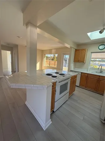 a large kitchen with stainless steel appliances a sink and cabinets