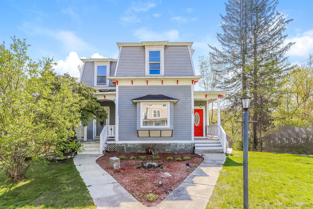 a front view of a house with garden