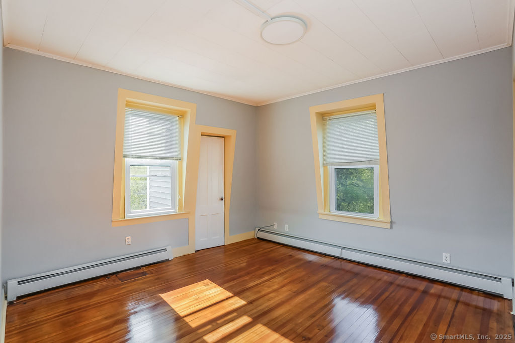 220 Walnut Street Winchester, CT 06098 - Photo 14 of 20 an empty room with wooden floor and windows