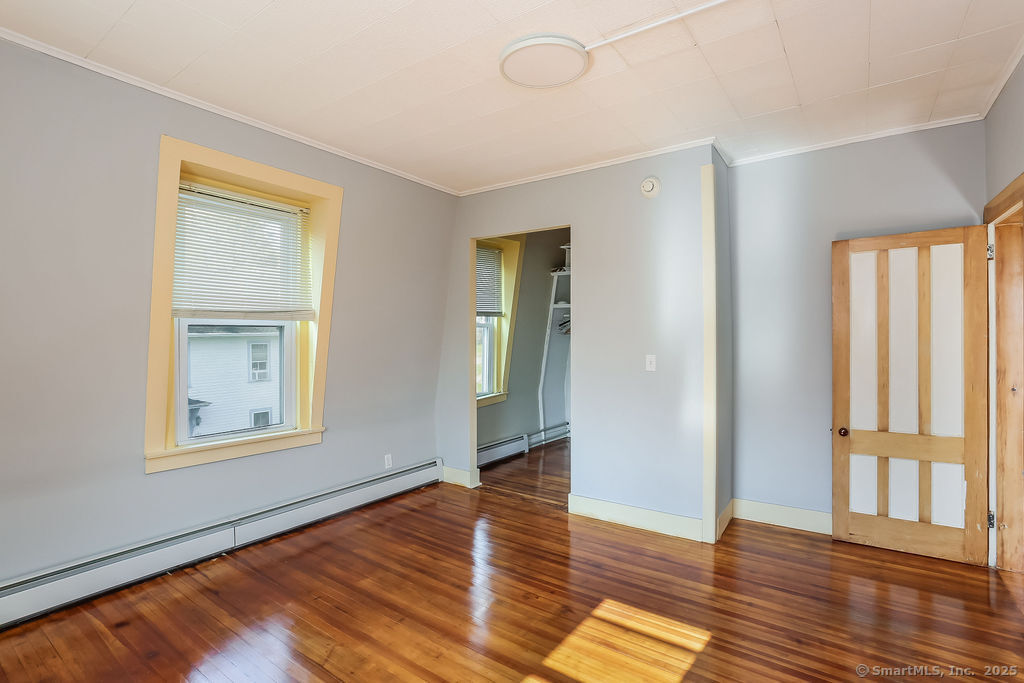 220 Walnut Street Winchester, CT 06098 - Photo 15 of 20 a view of an empty room with wooden floor and a window