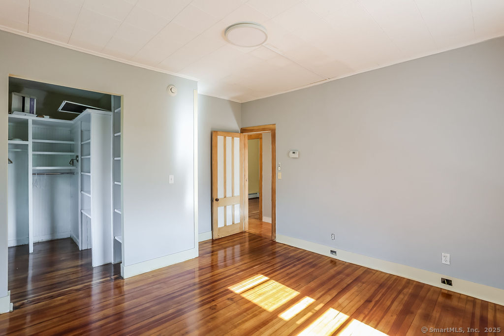 220 Walnut Street Winchester, CT 06098 - Photo 17 of 20 a view of an empty room with wooden floor and a window