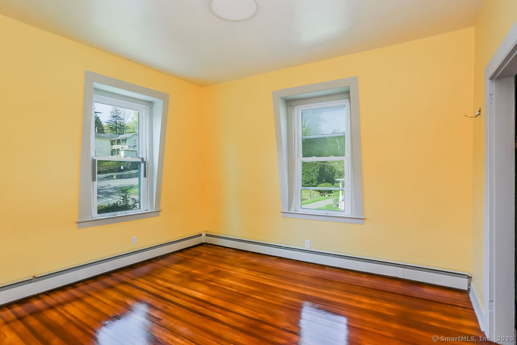 220 Walnut Street Winchester, CT 06098 - Photo 19 of 20 a view of an empty room with wooden floor and a window