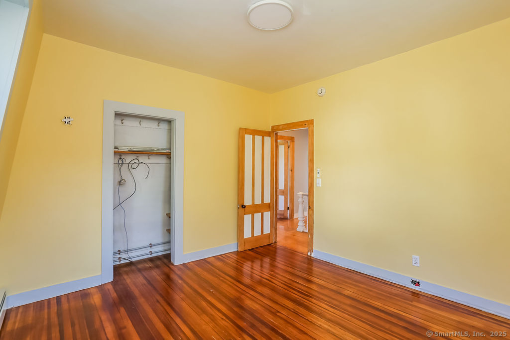 220 Walnut Street Winchester, CT 06098 - Photo 20 of 20 a view of an empty room with wooden floor and a window