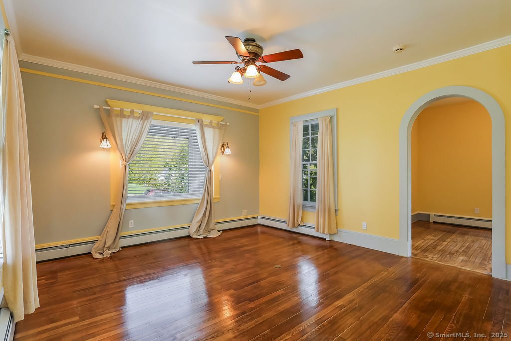 220 Walnut Street Winchester, CT 06098 - Photo 3 of 20 a view of an empty room with a window and wooden floor