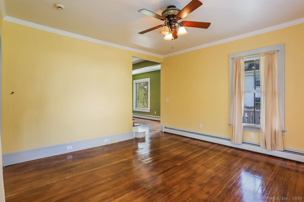 220 Walnut Street Winchester, CT 06098 - Photo 5 of 20 a view of an empty room with wooden floor and a window