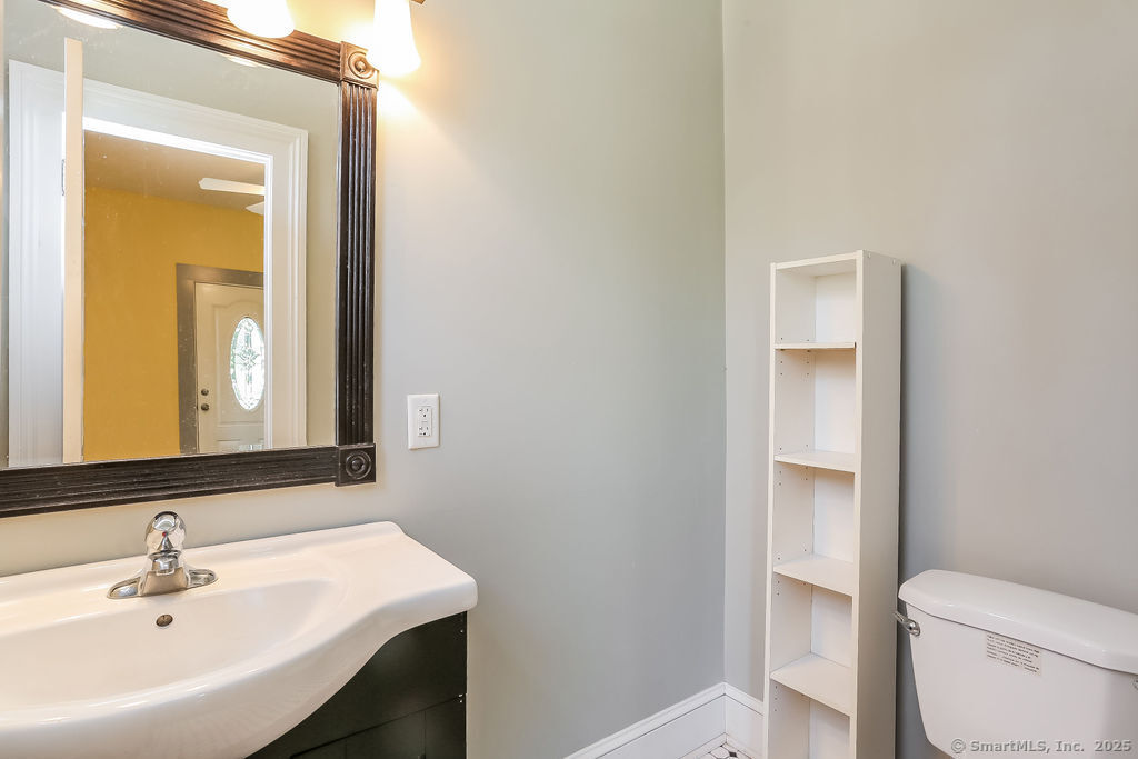 220 Walnut Street Winchester, CT 06098 - Photo 6 of 20 a bathroom with a sink a toilet and mirror