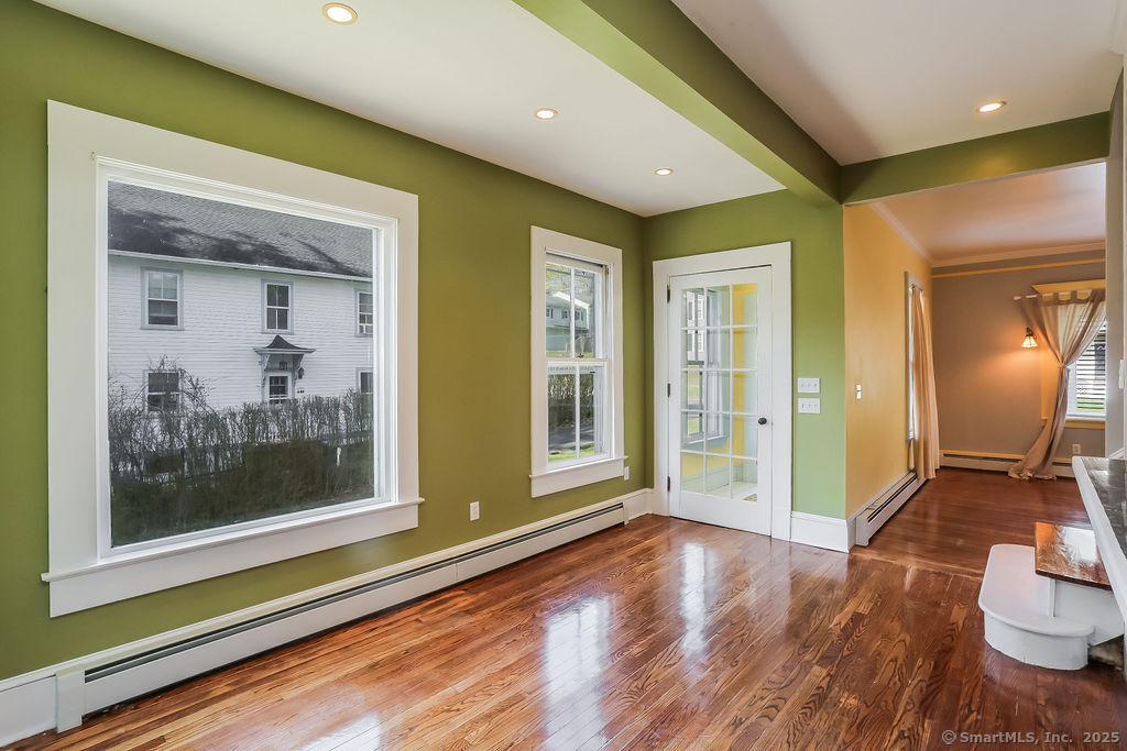 220 Walnut Street Winchester, CT 06098 - Photo 10 of 20 a view of a hallway with wooden floor and a living room
