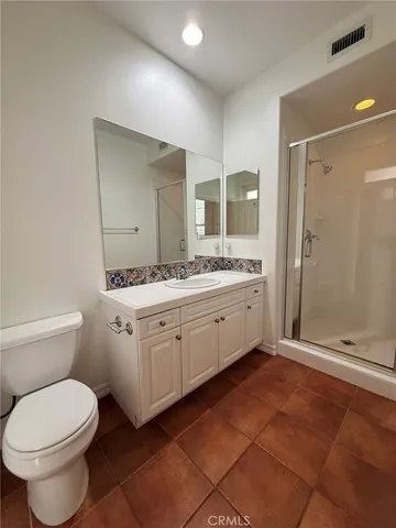 a spacious bathroom with a double vanity sink toilet and shower