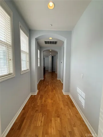 a view of a room with wooden floor and window
