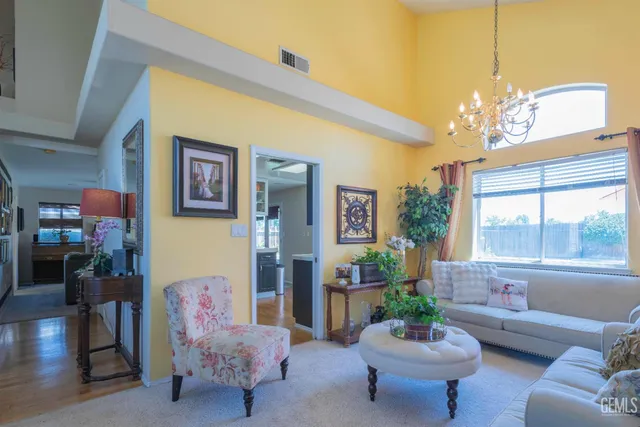 a living room with furniture and a chandelier
