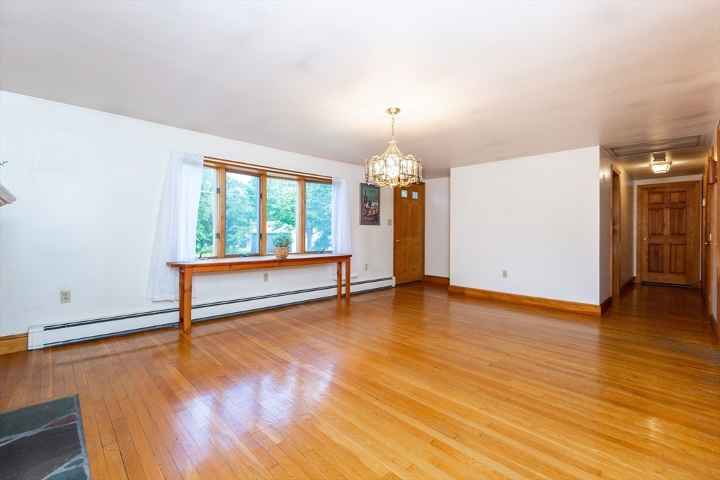 66 Depot Street Easton, MA 02375 - Photo 5 of 40 a view of an empty room with wooden floor and a window