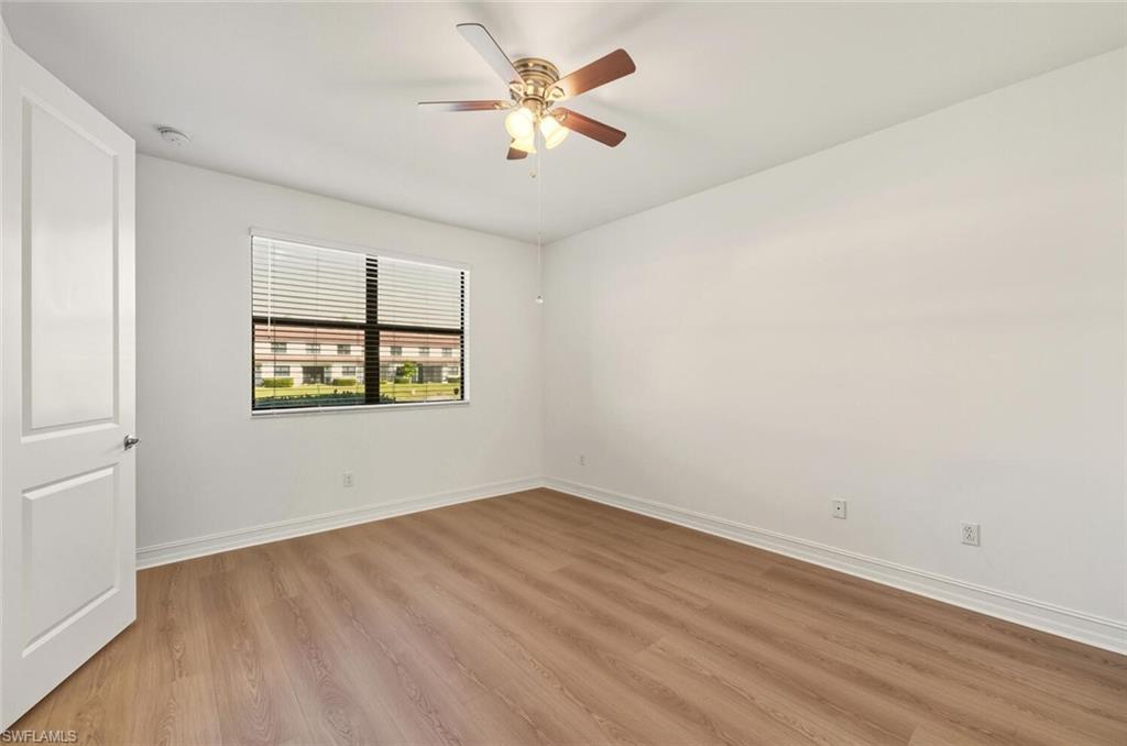 7770 Bristol Circle Naples, FL 34120 - Photo 10 of 36 Empty room with light wood-style flooring and a ceiling fan