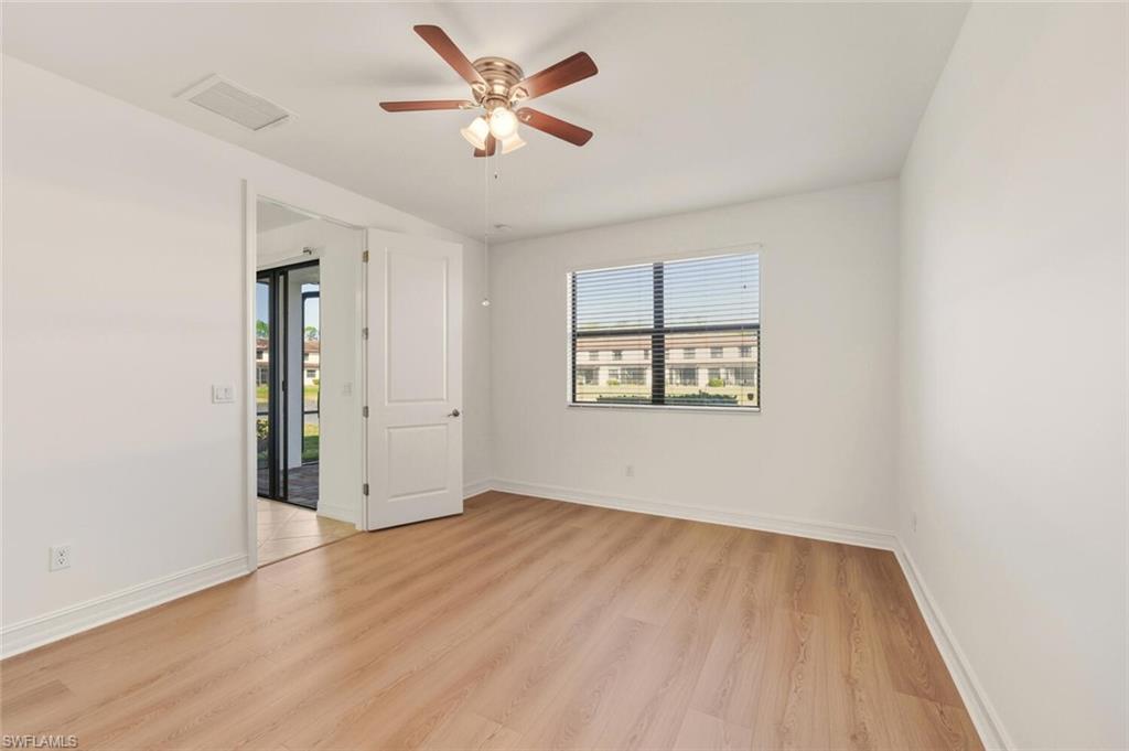 7770 Bristol Circle Naples, FL 34120 - Photo 11 of 36 Spare room featuring light wood-type flooring and a ceiling fan