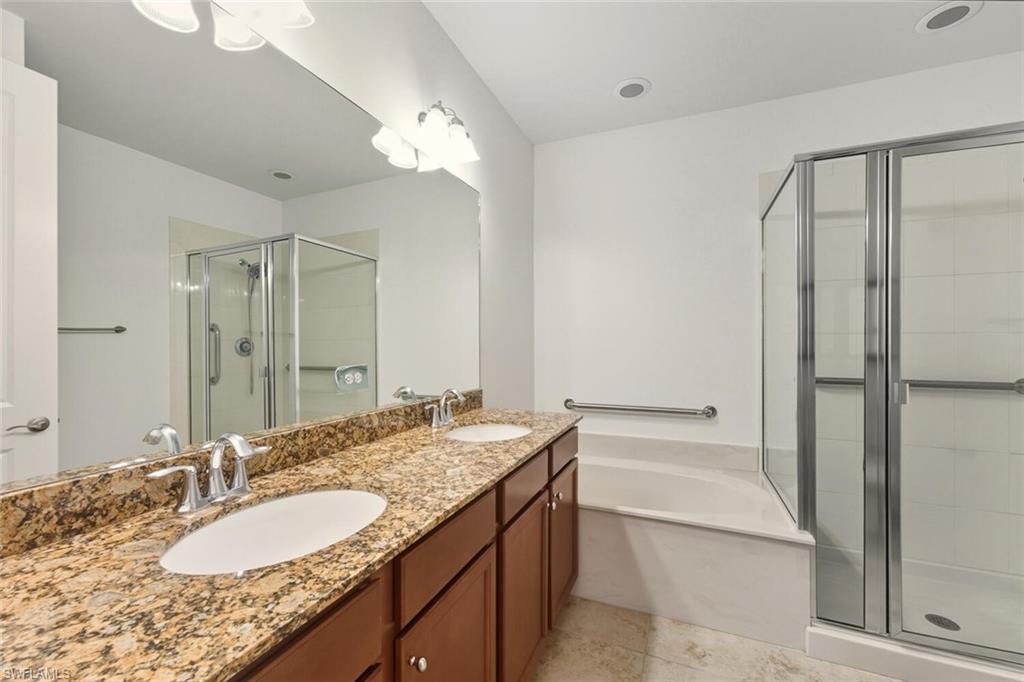 7770 Bristol Circle Naples, FL 34120 - Photo 13 of 36 Full bathroom with a stall shower, double vanity, and a bath