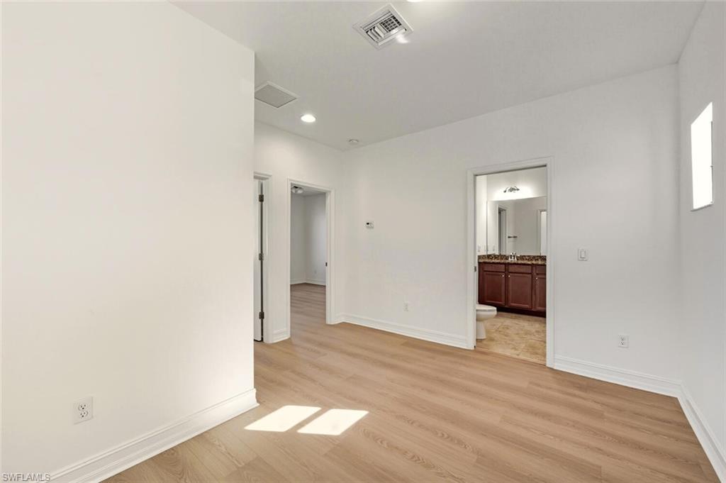 7770 Bristol Circle Naples, FL 34120 - Photo 15 of 36 Spare room with light wood-style flooring and recessed lighting
