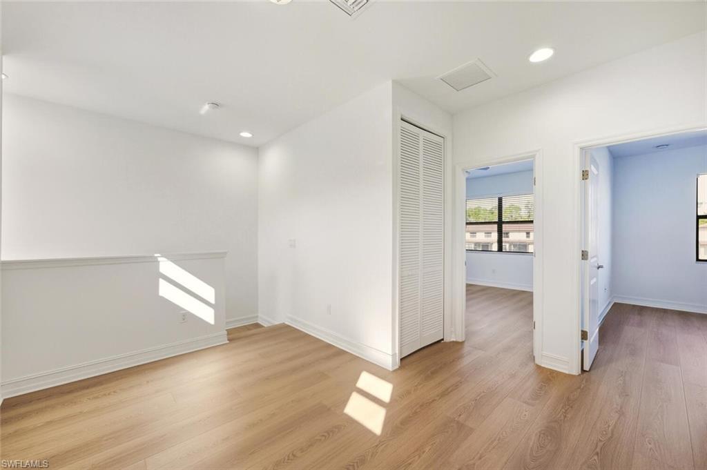 7770 Bristol Circle Naples, FL 34120 - Photo 17 of 36 Spare room with light wood finished floors and recessed lighting