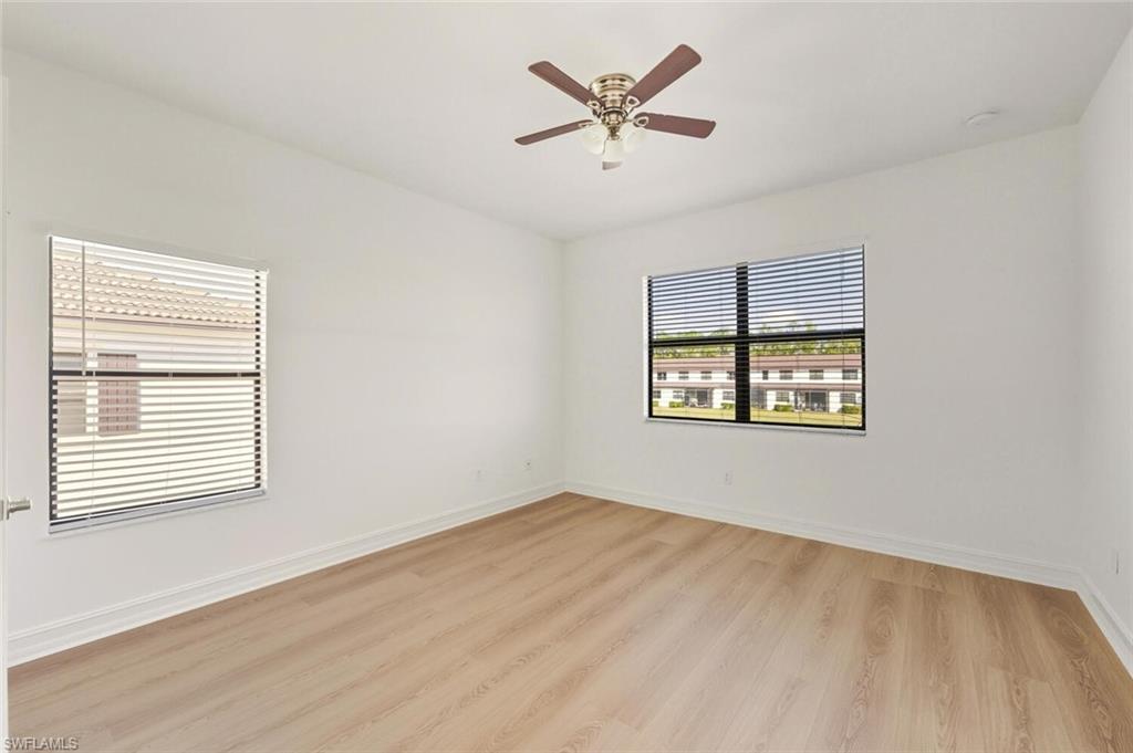 7770 Bristol Circle Naples, FL 34120 - Photo 22 of 36 Spare room featuring light wood finished floors and a ceiling fan